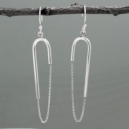 Discover the stunning Saha - RADA U Bar Silver Earrings - Dangle! These earrings are 53 mm long and 14 mm wide with a 1.4 mm tube's thickness, making them both elegant and durable. Their unique design measures 2 1/8 inches long by 11/16 inches wide and hangs 2 11/16 inches from the top of the ear wire. Handcrafted from .925 sterling silver with a high polished silver finish, these earrings provide a bold and dazzling look