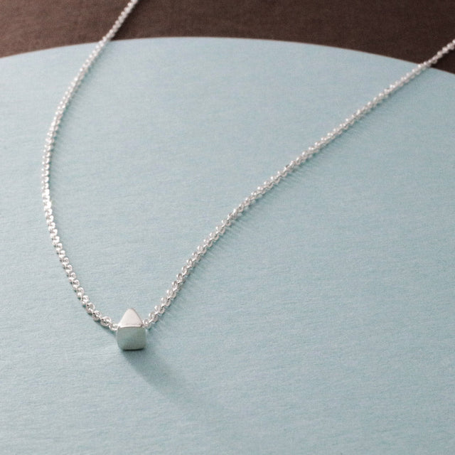 Piccoli - Tiny Triangle Silver Pendant Curated and designed by Emilio Sotelo Jewelry for Croi Kinsale Jewellery in Kinsale West Cork Ireland Europe. Find exceptional handmade silver and gold jewellery at affordable prices for birthday gifts and Christmas presents. Find Irish designers and makers. Beautiful jewellery shop located in Kinsale, Co. Cork.