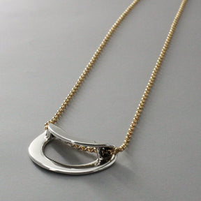 AYA - Round Off-Center Folded Silver Pendant Curated and designed by Emilio Sotelo Jewelry for Croi Kinsale Jewellery in Kinsale West Cork Ireland Europe. Find exceptional handmade silver and gold jewellery at affordable prices for birthday gifts and Christmas presents. Find Irish designers and makers. Beautiful jewellery shop located in Kinsale, Co. Cork.