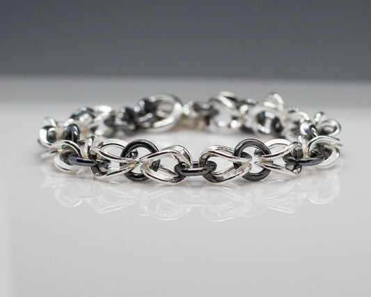This mesmerizing Alabina bracelet is 7 1/2 inches long and 19 centimeters long from end to end. Each of the dew drop beads measure 10 millimeters in diameter (1/2 inches) and are finished with a beautiful sterling silver toggle clasp. The sumptuous .925 sterling silver has a mesmerizing high-polished and oxidized finish that is certain to capture the eye.