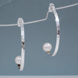 Artemis - Half Hoop Pearl Hammered Silver Earrings - Stud Curated and designed by Emilio Sotelo Jewelry for Croi Kinsale Jewellery in Kinsale West Cork Ireland Europe. Find exceptional handmade silver and gold jewellery at affordable prices for birthday gifts and Christmas presents. Handcrafted Silver jewelry. Find the best affordable jewellery