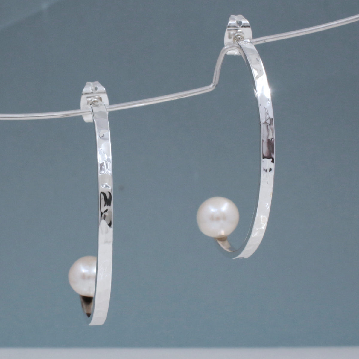Artemis - Half Hoop Pearl Hammered Silver Earrings - Stud Curated and designed by Emilio Sotelo Jewelry for Croi Kinsale Jewellery in Kinsale West Cork Ireland Europe. Find exceptional handmade silver and gold jewellery at affordable prices for birthday gifts and Christmas presents. Handcrafted Silver jewelry. Find the best affordable jewellery