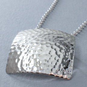 Artemis - Square Hammered Silver Pendant Curated and designed by Emilio Sotelo Jewelry for Croi Kinsale Jewellery in Kinsale West Cork Ireland Europe. Find exceptional handmade silver and gold jewellery at affordable prices for birthday gifts and Christmas presents. Find Irish designers and makers. Beautiful jewellery shop located in Kinsale, Co. Cork.