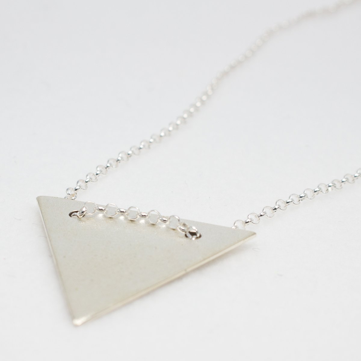 Artemis - Annia Triangle Matte Silver Pendant Curated and designed by Emilio Sotelo Jewelry for Croi Kinsale Jewellery in Kinsale West Cork Ireland Europe. Find exceptional handmade silver and gold jewellery at affordable prices for birthday gifts and Christmas presents. Find Irish designers and makers. Beautiful jewellery shop located in Kinsale, Co. Cork.