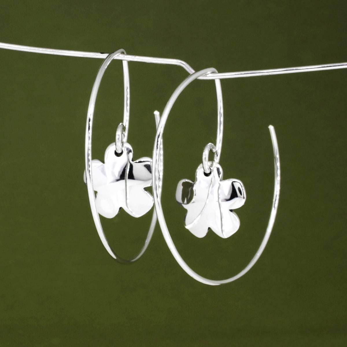 Moineir - Small Clover Reverse Hoop Silver Earrings Curated and designed by Emilio Sotelo Jewelry for Croi Kinsale Jewellery in Kinsale West Cork Ireland Europe. Find exceptional handmade silver and gold jewellery at affordable prices for birthday gifts and Christmas presents. Handcrafted Silver jewelry. The best affordable jewellery