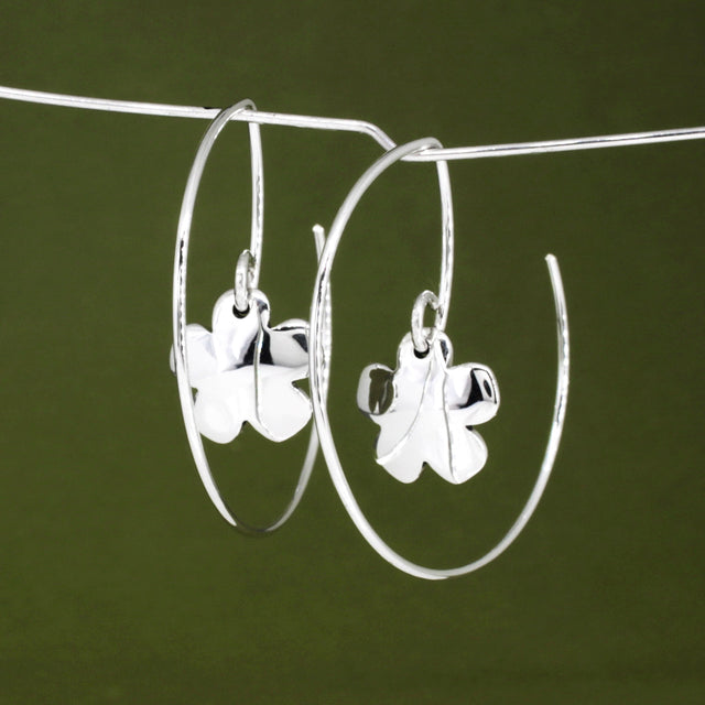 Moineir - Small Clover Reverse Hoop Silver Earrings Curated and designed by Emilio Sotelo Jewelry for Croi Kinsale Jewellery in Kinsale West Cork Ireland Europe. Find exceptional handmade silver and gold jewellery at affordable prices for birthday gifts and Christmas presents. Handcrafted Silver jewelry. The best affordable jewellery