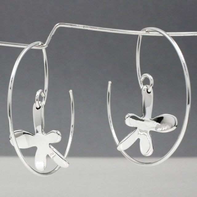 Moineir - Small Happy Daisy Reverse Hoop Silver Earrings Curated and designed by Emilio Sotelo Jewelry for Croi Kinsale Jewellery in Kinsale West Cork Ireland Europe. Find exceptional handmade silver and gold jewellery at affordable prices for birthday gifts and Christmas presents. Handcrafted Silver jewelry. The best affordable jewellery