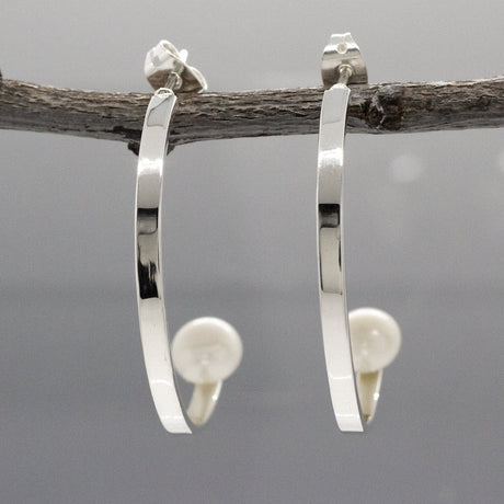 Artemis - Half Hoop Pearl Silver Earrings - Stud Curated and designed by Emilio Sotelo Jewelry for Croi Kinsale Jewellery in Kinsale West Cork Ireland Europe. Find exceptional handmade silver and gold jewellery at affordable prices for birthday gifts and Christmas presents. Handcrafted Silver jewelry. Find the best affordable jewellery